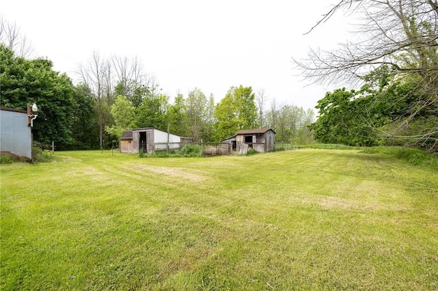 6695 Fisher Rd, Ontario, NY 14589 - view of green lawn featuring an outbuilding and a barn