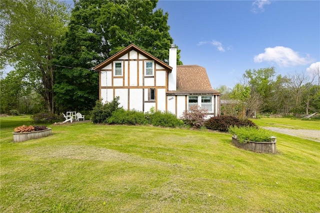 6695 Fisher Rd, Ontario, NY 14589 - view of front of house featuring a chimney and a front yard