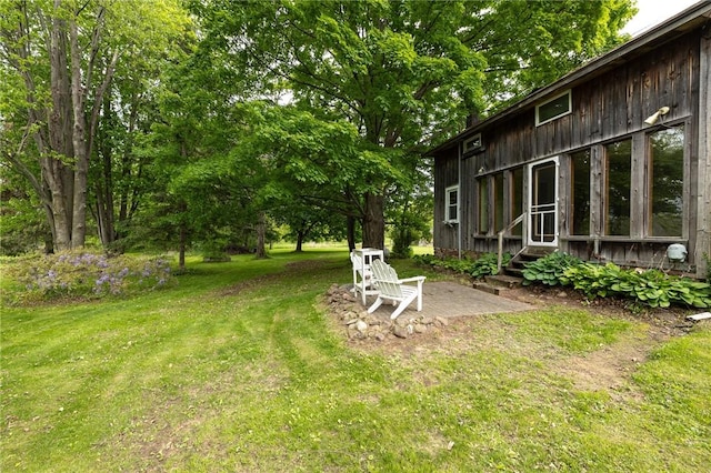 6695 Fisher Rd, Ontario, NY 14589 - view of green lawn featuring entry steps and a patio