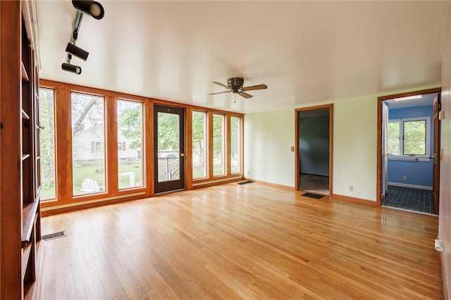 6695 Fisher Rd, Ontario, NY 14589 - unfurnished living room with light wood-style floors, a ceiling fan, track lighting, and baseboards