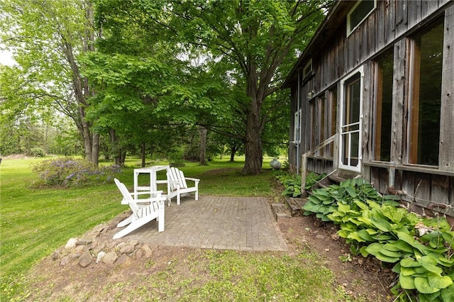 6695 Fisher Rd, Ontario, NY 14589 - view of grassy yard with a patio area