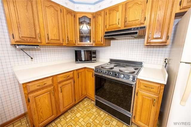 4314 Elmwood Ave, Hamburg, NY 14219 - kitchen with range with electric stovetop, under cabinet range hood, freestanding refrigerator, and light countertops