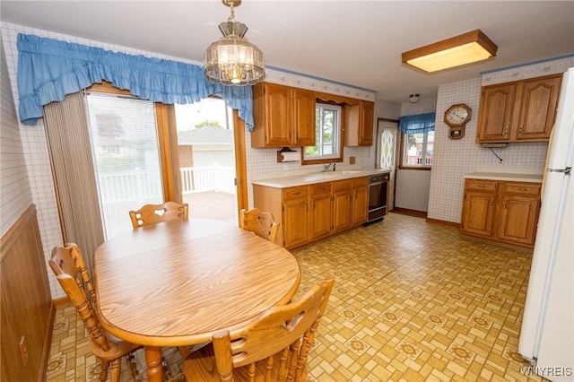 4314 Elmwood Ave, Hamburg, NY 14219 - dining area with wallpapered walls, a chandelier, and baseboards