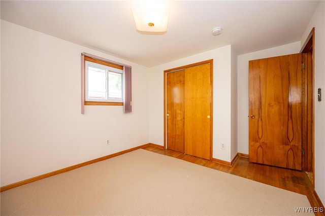 4314 Elmwood Ave, Hamburg, NY 14219 - unfurnished bedroom featuring a closet, baseboards, and wood finished floors