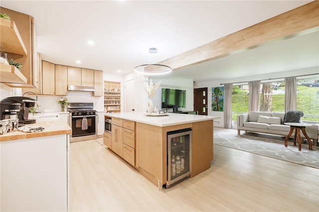 182 Stony Point Trl, Webster, NY 14580 - kitchen featuring black gas range oven, wine cooler, light brown cabinets, under cabinet range hood, and light wood-style flooring