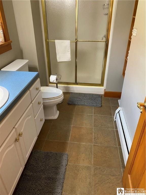 6753 Poverty Hill Rd, Ellicottville, NY 14731 - full bath with toilet, vanity, a shower stall, baseboard heating, and tile patterned floors