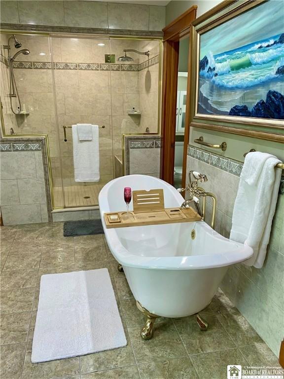 6753 Poverty Hill Rd, Ellicottville, NY 14731 - bathroom with tile walls, a shower stall, and tile patterned flooring