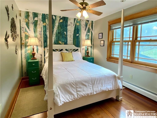 6753 Poverty Hill Rd, Ellicottville, NY 14731 - bedroom featuring wood finished floors, a baseboard heating unit, and baseboards