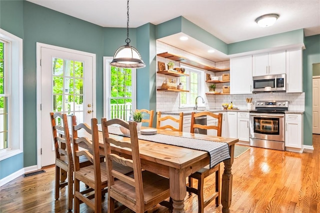 169 Watson Rd, Penfield, NY 14450 - dining area with light wood-style flooring and baseboards