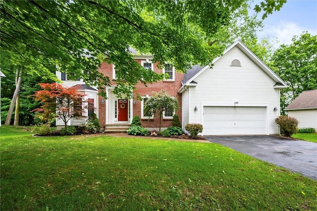 169 Watson Rd, Penfield, NY 14450 - colonial-style house featuring driveway, brick siding, a front yard, and an attached garage