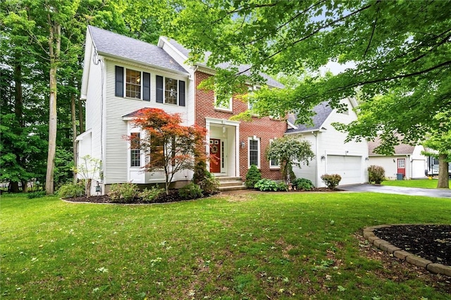 169 Watson Rd, Penfield, NY 14450 - colonial house with driveway, a garage, a front yard, and brick siding