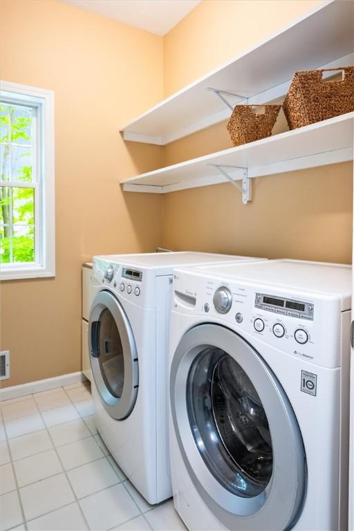169 Watson Rd, Penfield, NY 14450 - washroom featuring independent washer and dryer, baseboards, and light tile patterned flooring