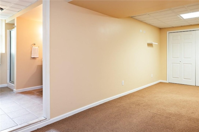 169 Watson Rd, Penfield, NY 14450 - unfurnished bedroom featuring baseboards, a paneled ceiling, light carpet, and a closet