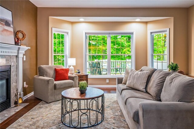 169 Watson Rd, Penfield, NY 14450 - living area featuring a tile fireplace, baseboards, wood finished floors, and plenty of natural light