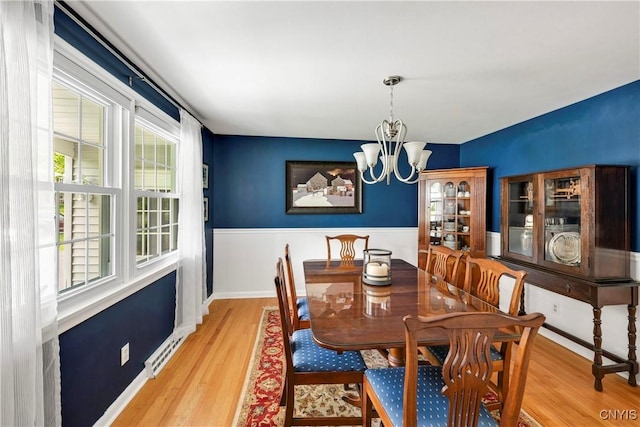 8260 Dexter Pkwy, Lysander, NY 13027 - dining room with a chandelier, plenty of natural light, and wood finished floors
