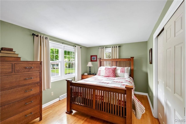 8260 Dexter Pkwy, Lysander, NY 13027 - bedroom featuring light wood finished floors, baseboards, and a closet