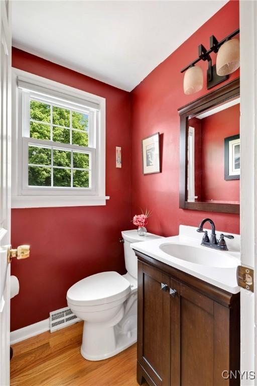 8260 Dexter Pkwy, Lysander, NY 13027 - bathroom featuring vanity, toilet, and wood finished floors