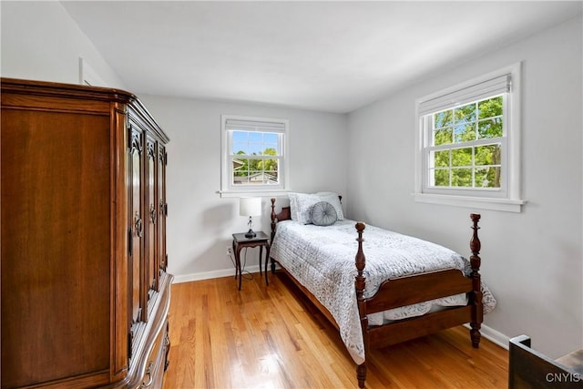 8260 Dexter Pkwy, Lysander, NY 13027 - bedroom with multiple windows, baseboards, and light wood-style flooring