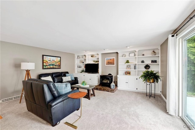 8260 Dexter Pkwy, Lysander, NY 13027 - living room featuring a wood stove, light carpet, built in features, and baseboards