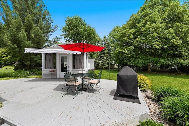 8260 Dexter Pkwy, Lysander, NY 13027 - wooden terrace with outdoor dining area, a grill, a lawn, and an outbuilding