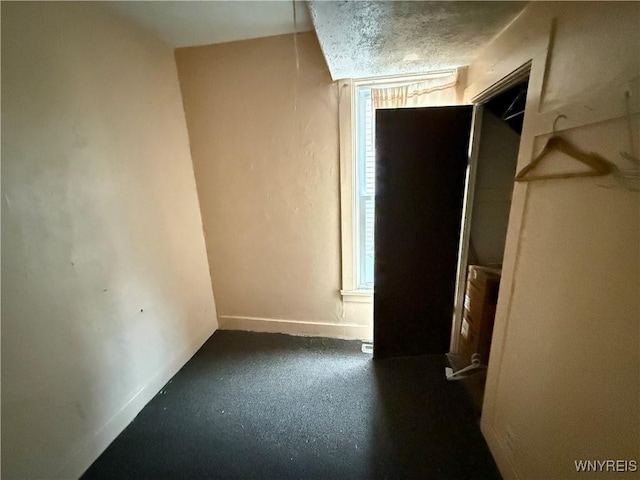 114 19th St, Buffalo, NY 14213 - unfurnished bedroom with baseboards, multiple windows, and a textured ceiling
