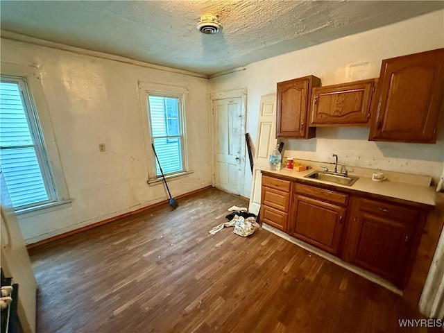 114 19th St, Buffalo, NY 14213 - kitchen featuring a sink, dark wood finished floors, light countertops, brown cabinets, and a textured ceiling