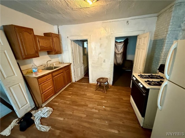 114 19th St, Buffalo, NY 14213 - kitchen featuring white appliances, dark wood finished floors, a sink, light countertops, and brown cabinetry