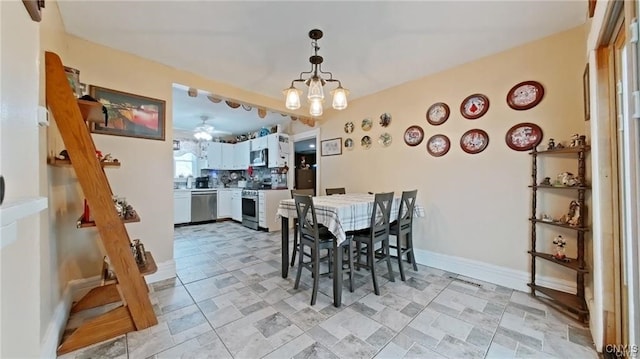 801 W Thomas St, Rome-Inside, NY 13440 - dining space with a chandelier, a ceiling fan, and baseboards