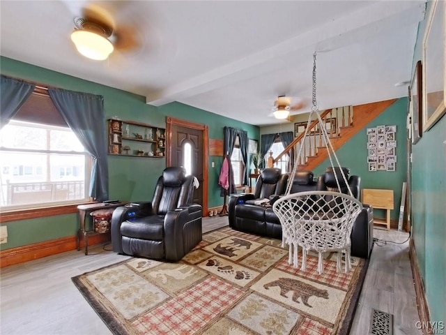 801 W Thomas St, Rome-Inside, NY 13440 - living area with beam ceiling, wood finished floors, baseboards, ceiling fan, and stairway