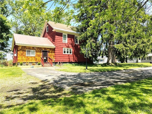 801 W Thomas St, Rome-Inside, NY 13440 - view of front of house featuring asphalt driveway and a front lawn
