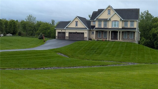 12 Probst Rd, Mendon, NY 14534 - view of front facade featuring driveway, an attached garage, stone siding, and a front yard