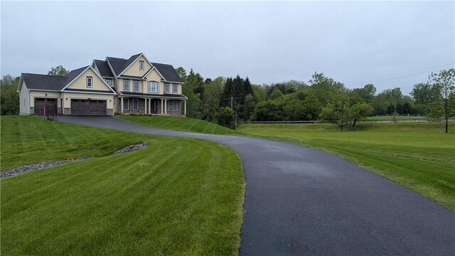 12 Probst Rd, Mendon, NY 14534 - view of home's community with asphalt driveway, a garage, and a lawn