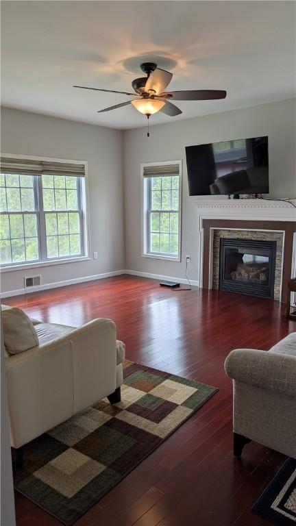 12 Probst Rd, Mendon, NY 14534 - living area with wood finished floors, a glass covered fireplace, and ceiling fan