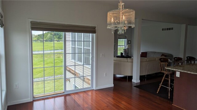 12 Probst Rd, Mendon, NY 14534 - dining area featuring dark wood-style flooring, a chandelier, and plenty of natural light