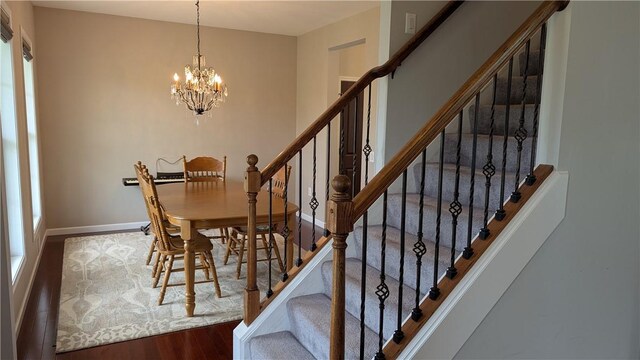 12 Probst Rd, Mendon, NY 14534 - dining area featuring a chandelier, wood finished floors, and stairway