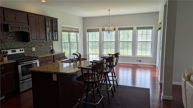 12 Probst Rd, Mendon, NY 14534 - kitchen featuring stainless steel electric range, decorative backsplash, a breakfast bar, stone countertops, and glass insert cabinets