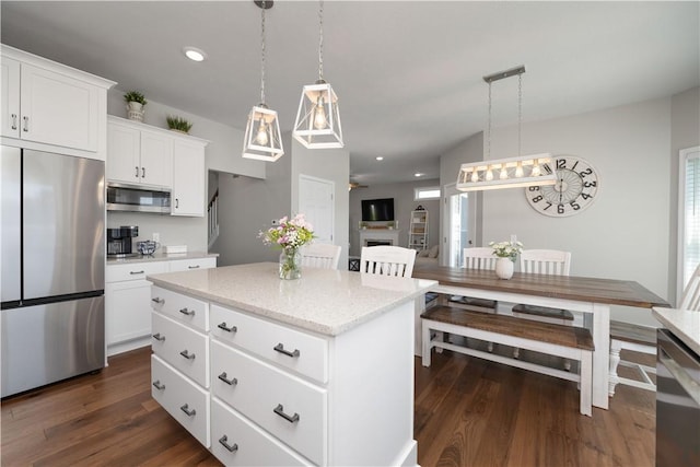8 Giovanni Ln, Parma, NY 14468 - kitchen featuring stainless steel appliances, dark wood finished floors, a center island, decorative light fixtures, and recessed lighting