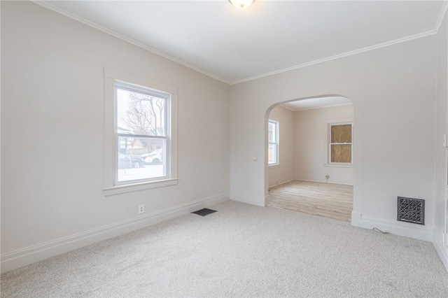 7 Herbert St, Rochester, NY 14621 - carpeted empty room with arched walkways, crown molding, and baseboards