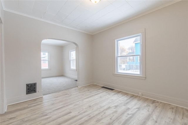 7 Herbert St, Rochester, NY 14621 - unfurnished room featuring ornamental molding, arched walkways, light wood-type flooring, and baseboards