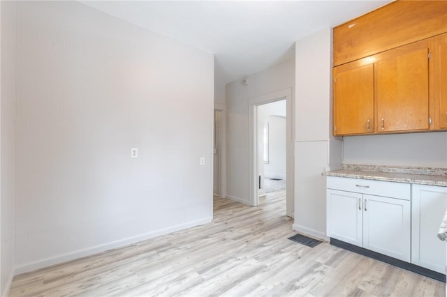 7 Herbert St, Rochester, NY 14621 - kitchen with light wood finished floors, baseboards, and brown cabinetry