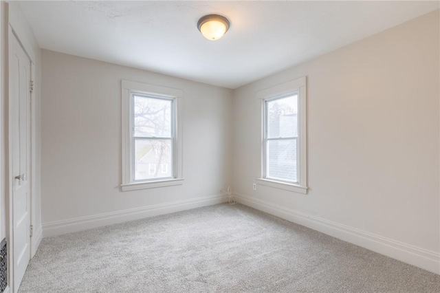 7 Herbert St, Rochester, NY 14621 - unfurnished bedroom with multiple windows, baseboards, and light colored carpet