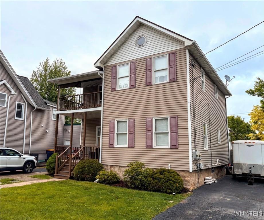 301 Locust St, Lockport-City, NY 14094 - view of front of property featuring a balcony and a front yard