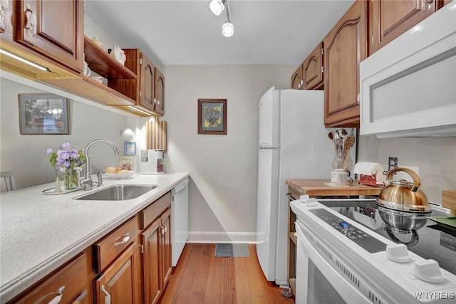 270 Buffalo Rd Unit 72, Aurora, NY 14052 - kitchen with white appliances, a sink, wood finished floors, and light countertops