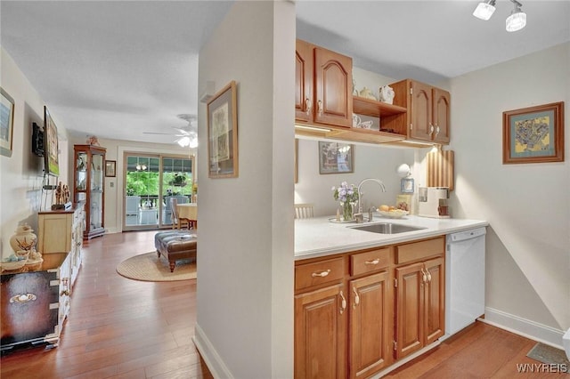 270 Buffalo Rd Unit 72, Aurora, NY 14052 - kitchen with a sink, white dishwasher, light wood finished floors, and light countertops