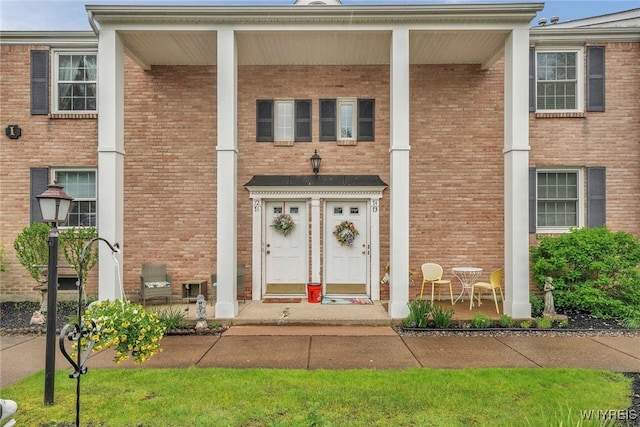 270 Buffalo Rd Unit 72, Aurora, NY 14052 - doorway to property with covered porch and brick siding