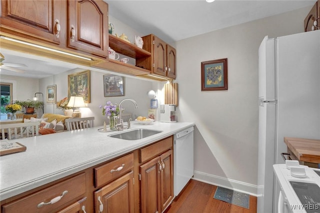 270 Buffalo Rd Unit 72, Aurora, NY 14052 - kitchen featuring white appliances, a sink, light countertops, open shelves, and brown cabinetry
