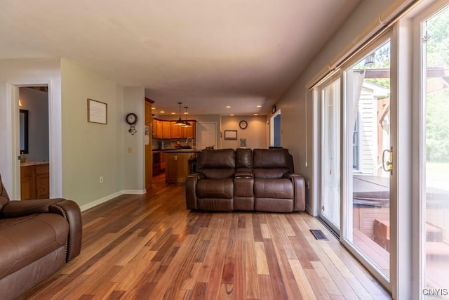 3 Foxwood Dr, Lysander, NY 13027 - living area with wood finished floors, baseboards, and recessed lighting
