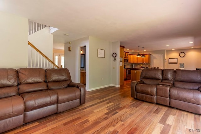 3 Foxwood Dr, Lysander, NY 13027 - living area featuring wood finished floors, stairs, recessed lighting, and baseboards