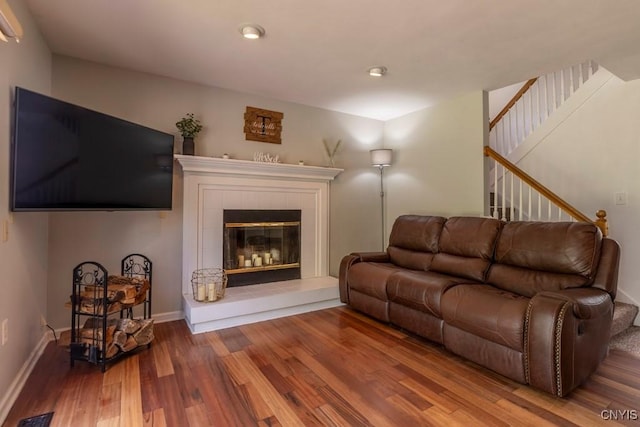 3 Foxwood Dr, Lysander, NY 13027 - living area with wood finished floors, stairway, a fireplace, baseboards, and recessed lighting