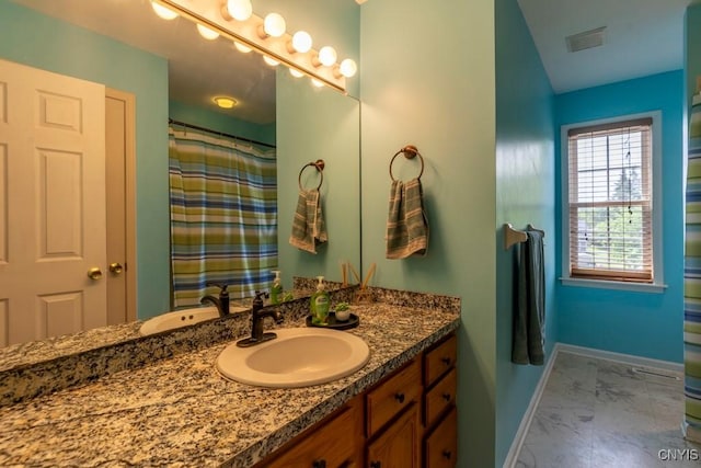 3 Foxwood Dr, Lysander, NY 13027 - bathroom featuring marble look tiles, baseboards, and vanity